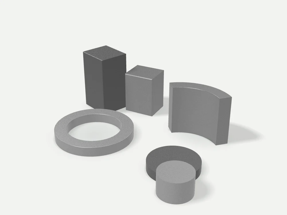 Illustrative matte-grey block, ring, cylindrical and arc magnets in a light studio